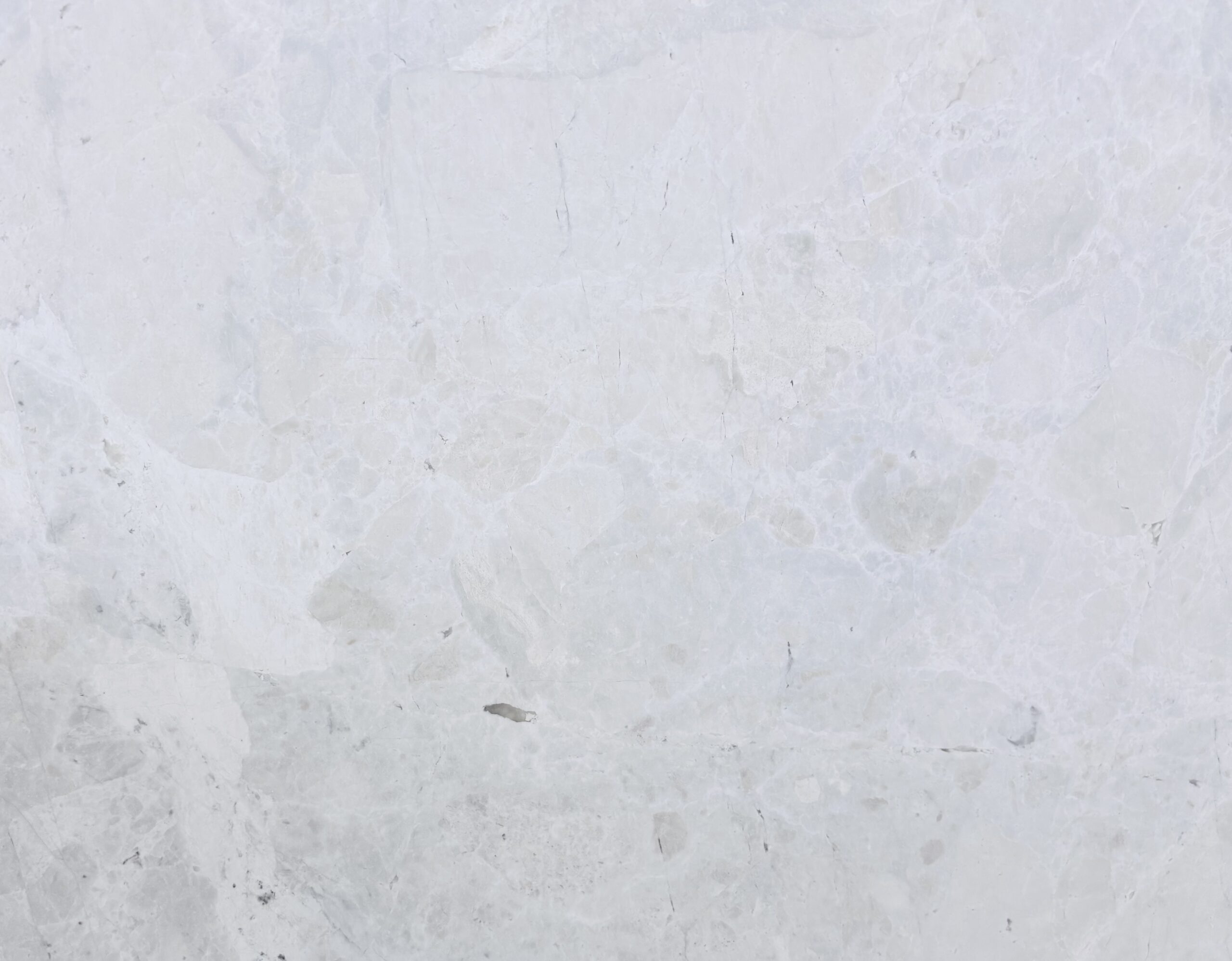 French Vanilla Turkish marble slab surface, white ground with a cloudy, patchy pattern and light pink clouds in places