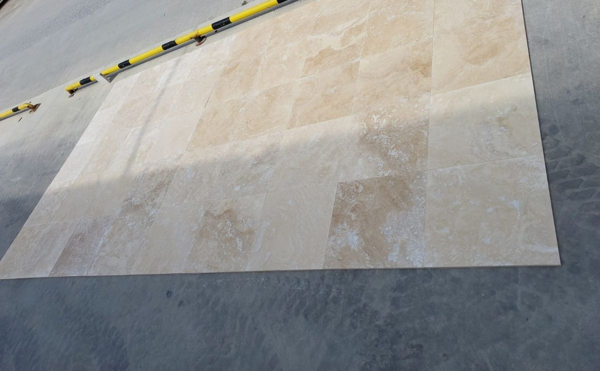 Light-Medium cross cut travertine tiles laid out for checking