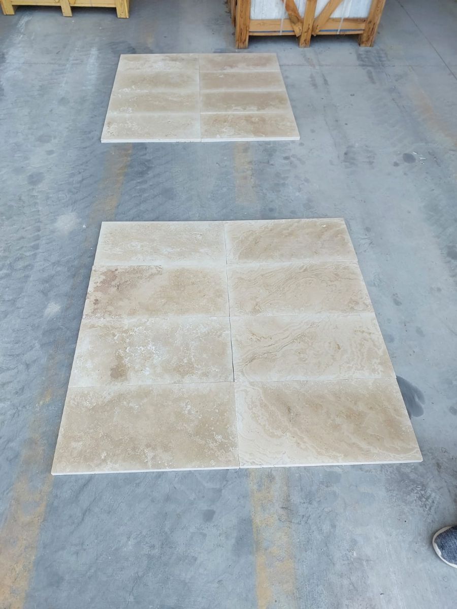 Light travertine tiles laid out before packing