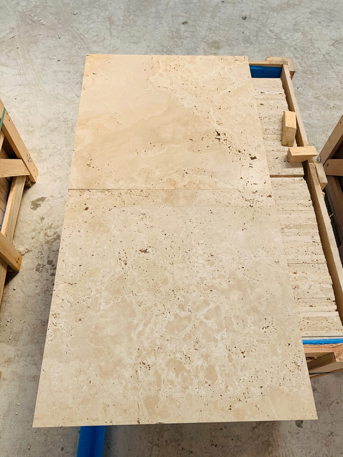 Unfilled raw light travertine tiles with open holes on the surface
