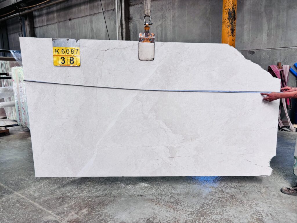 Marble slab measured with a tape for size control at the factory
